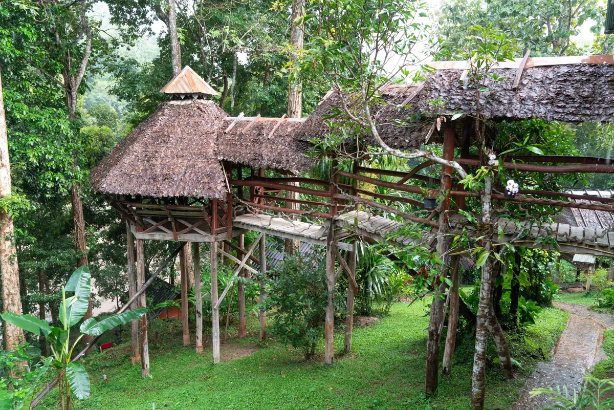 The open teak main house and common area at Cave Lodge